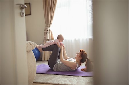 feet up girls - Happy mother and baby exercising on mat at home Stock Photo - Premium Royalty-Free, Code: 6109-08945244