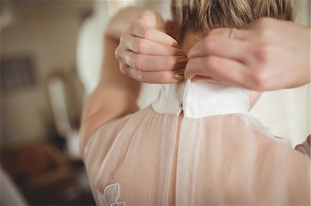 simsearch:6109-08945282,k - Rear view of bride wearing wedding dress at boutique Stock Photo - Premium Royalty-Free, Code: 6109-08945256