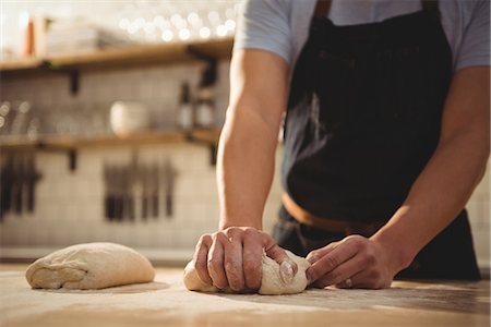 employees industry - Mid section of male chef kneading dough in commercial kitchen Stock Photo - Premium Royalty-Free, Code: 6109-08945372