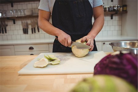 simsearch:6109-08489857,k - Midsection of male chef cutting cabbage on cutting board in commercial kitchen Stock Photo - Premium Royalty-Free, Code: 6109-08945377