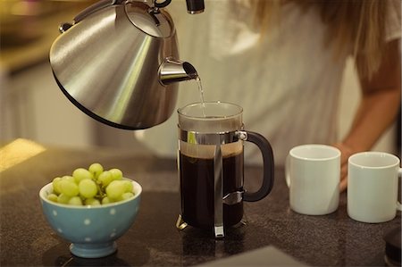 simsearch:6109-06781541,k - Close-up of woman preparing coffee at home Stock Photo - Premium Royalty-Free, Code: 6109-08945465