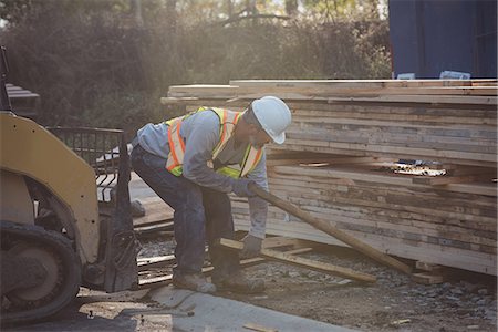 Construction worker working at construction site Stock Photo - Premium Royalty-Free, Code: 6109-08952844