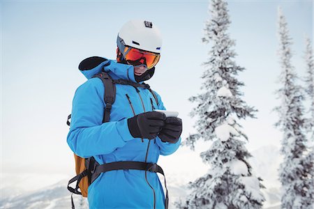 simsearch:6109-08953148,k - Skier using mobile phone on snowy mountains Stock Photo - Premium Royalty-Free, Code: 6109-08952944