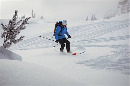 simsearch:6109-08944908,k - Skier skiing on snow covered mountains Stock Photo - Premium Royalty-Free, Code: 6109-08952950