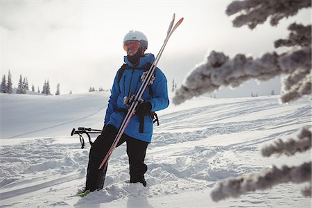 simsearch:6109-08944908,k - Skier walking with ski on snowy mountain Stock Photo - Premium Royalty-Free, Code: 6109-08952952