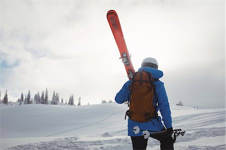simsearch:6109-08944908,k - Skier walking with ski on snowy mountain Stock Photo - Premium Royalty-Free, Code: 6109-08952954