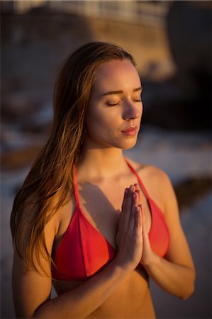 Beautiful woman meditating on beach Stock Photo - Premium Royalty-Free, Code: 6109-08952994