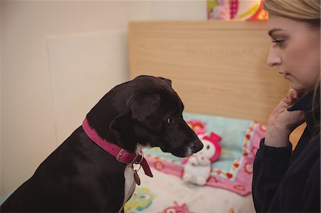 Woman looking at black beagle dog Stock Photo - Premium Royalty-Free, Code: 6109-08952932