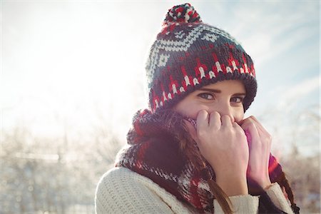 simsearch:6109-08953148,k - Beautiful woman in warm clothing covering her mouth with jumper Stock Photo - Premium Royalty-Free, Code: 6109-08953163