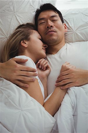 sleeping in female partner hug pic - Couple sleeping together in bedroom Stock Photo - Premium Royalty-Free, Code: 6109-08953106