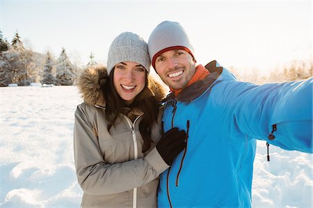 simsearch:6128-08738364,k - Happy couple taking a selfie on snowy landscape Stock Photo - Premium Royalty-Free, Code: 6109-08953224