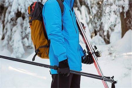 simsearch:6109-06195607,k - Skier walking with ski on snow covered mountains Photographie de stock - Premium Libres de Droits, Code: 6109-08953229