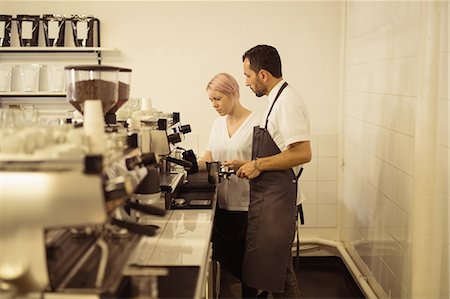 filter - Male and female barista preparing coffee together in the coffee shop Stock Photo - Premium Royalty-Free, Code: 6109-08953387