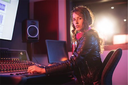 simsearch:6109-08802462,k - Portrait of female audio engineer using sound mixer in recording studio Stock Photo - Premium Royalty-Free, Code: 6109-08953685