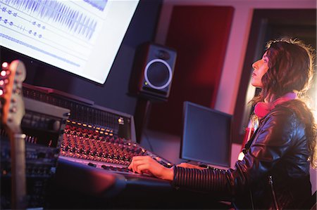 synthesizer - Female audio engineer using sound mixer in recording studio Stock Photo - Premium Royalty-Free, Code: 6109-08953686