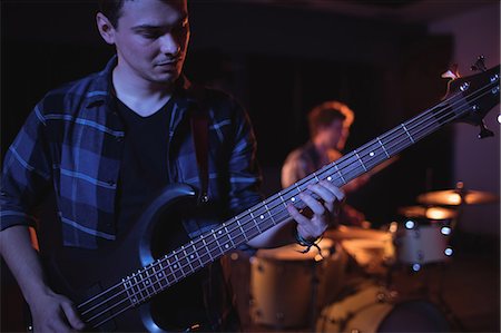 rock band performing - Guitarist playing electric guitar in recording studio Stock Photo - Premium Royalty-Free, Code: 6109-08953705