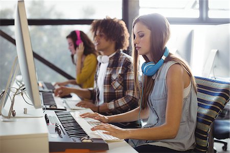 simsearch:6109-08802462,k - Attentive female sound engineer and colleagues working in office Stock Photo - Premium Royalty-Free, Code: 6109-08953709