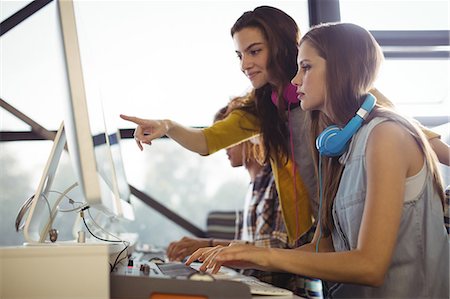 simsearch:6109-08802462,k - Attentive female sound engineer and colleagues working in office Stock Photo - Premium Royalty-Free, Code: 6109-08953710