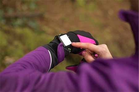 simsearch:6109-08830642,k - Mid section of woman using smart watch in the forest Stock Photo - Premium Royalty-Free, Code: 6109-08953856