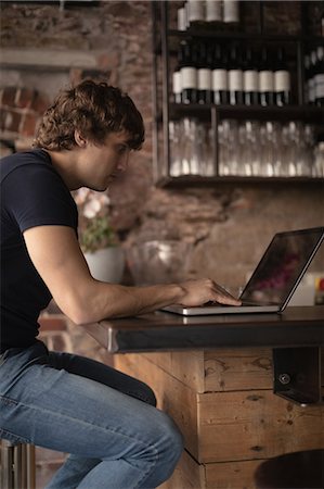 simsearch:6109-08953870,k - Attentive man using laptop in Café Stock Photo - Premium Royalty-Free, Code: 6109-08953873