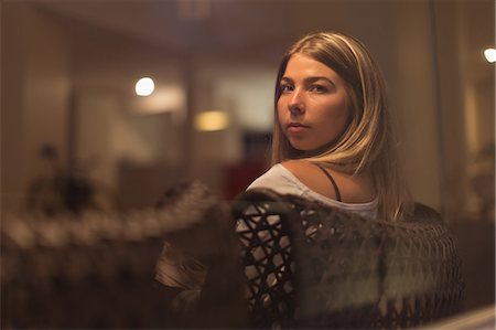 simsearch:6109-08537404,k - Thoughtful woman relaxing on chair and looking through window at home Stock Photo - Premium Royalty-Free, Code: 6109-08953940