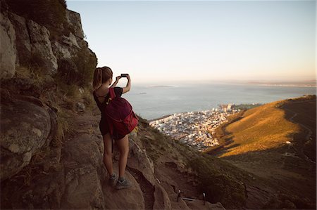 simsearch:6109-08536382,k - Rear view of woman taking a photo with a camera Photographie de stock - Premium Libres de Droits, Code: 6109-08953972