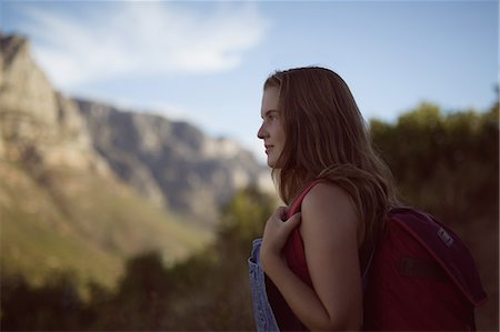 simsearch:6109-08581912,k - Rear view of woman standing with backpack in countryside Foto de stock - Sin royalties Premium, Código: 6109-08953988