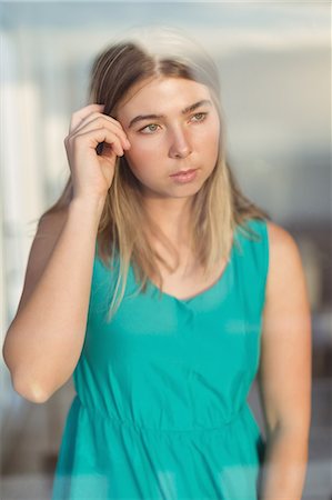 simsearch:6109-08537404,k - Thoughtful woman standing near window at home Stock Photo - Premium Royalty-Free, Code: 6109-08953933