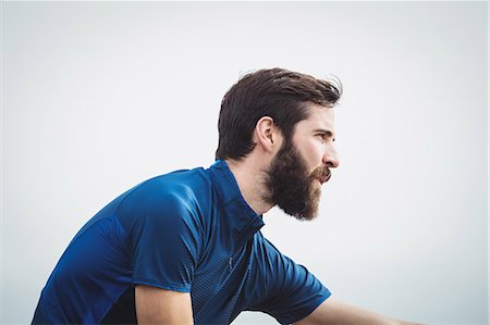 Close up of a handsome athlete stretching Stock Photo - Premium Royalty-Free, Code: 6109-08928456