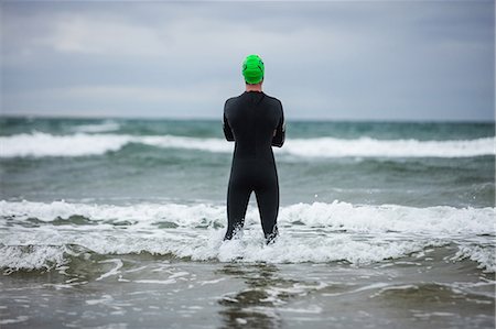 simsearch:6109-08928512,k - Rear view of athlete standing in the sea on beach Stock Photo - Premium Royalty-Free, Code: 6109-08928474