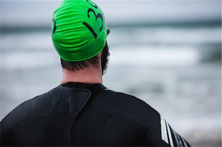 simsearch:400-03956564,k - Rear view of athlete in wet suit standing Fotografie stock - Premium Royalty-Free, Codice: 6109-08928486