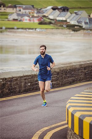 simsearch:6109-08928512,k - Handsome athlete running on the road Stock Photo - Premium Royalty-Free, Code: 6109-08928502
