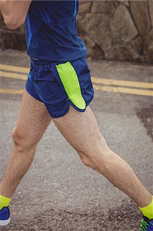 simsearch:649-03511148,k - Low section of athlete running on the road Photographie de stock - Premium Libres de Droits, Code: 6109-08928504