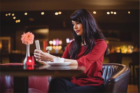 simsearch:6109-07600968,k - Woman using mobile phone in restaurant Stock Photo - Premium Royalty-Free, Code: 6109-08928662