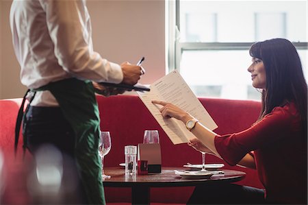 simsearch:6109-08801968,k - Waiter taking order from woman in a restaurant Photographie de stock - Premium Libres de Droits, Code: 6109-08928674