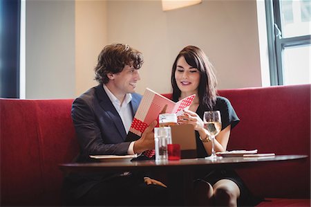 restaurant not child not computer not phone not kitchen not chef not waiter not outdoors not asian not lantern not asia - Couple holding a menu in restaurant Stock Photo - Premium Royalty-Free, Code: 6109-08928680