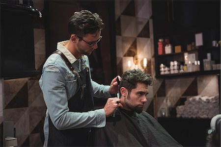 simsearch:640-03264063,k - Man getting his hair trimmed with razor in baber shop Foto de stock - Sin royalties Premium, Código: 6109-08928780