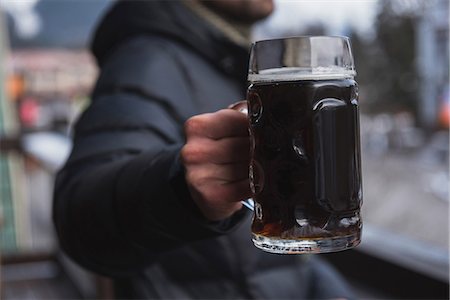 Close-up of man holding a glass of beer Stock Photo - Premium Royalty-Free, Code: 6109-08928857