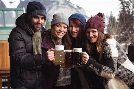 pub - Portrait of happy friends toasting with beer glasses in bar Stock Photo - Premium Royalty-Free, Code: 6109-08928863