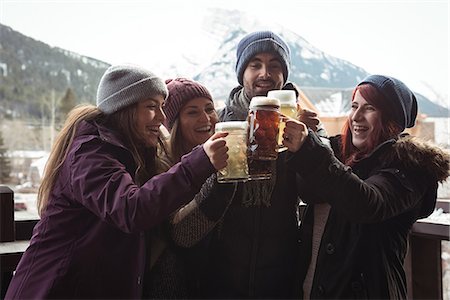 Happy friends toasting with beer glasses in bar Stock Photo - Premium Royalty-Free, Code: 6109-08928862