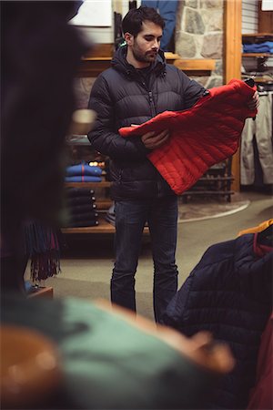 simsearch:693-03707603,k - Man selecting apparel in a clothes shop Stock Photo - Premium Royalty-Free, Code: 6109-08928893