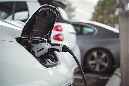 simsearch:6109-08929014,k - Close-up of car being charged with electric car charger at charging station Stock Photo - Premium Royalty-Free, Code: 6109-08929048