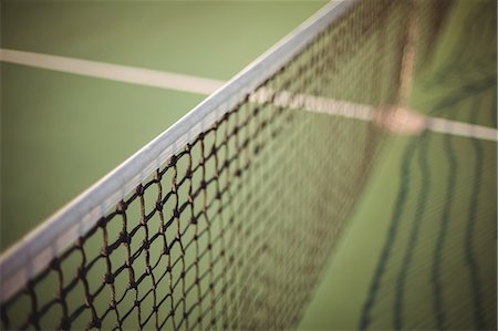 quadra (esportes) - Close-up of net in tennis court Foto de stock - Royalty Free Premium, Número: 6109-08929210