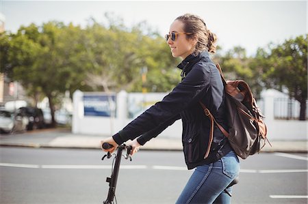 simsearch:862-05996818,k - Woman riding a bicycle on the road Stock Photo - Premium Royalty-Free, Code: 6109-08929225