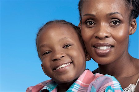 simsearch:6110-06702656,k - Closeup portrait of young African girl and her mother Foto de stock - Royalty Free Premium, Número: 6110-06702642