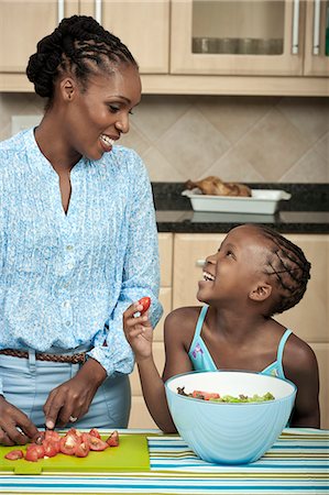 simsearch:6110-06702656,k - Young African child preparing food with her mother Foto de stock - Royalty Free Premium, Número: 6110-06702659