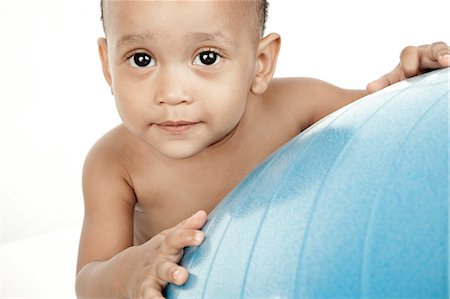 simsearch:6110-06702760,k - Infant sitting in front of a white background with an exercise ball Fotografie stock - Premium Royalty-Free, Codice: 6110-06702765