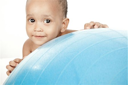 simsearch:6110-06702760,k - Infant sitting in front of a white background with an exercise ball Fotografie stock - Premium Royalty-Free, Codice: 6110-06702766