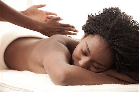 Young black woman in a salon receiving a back massage Fotografie stock - Premium Royalty-Free, Codice: 6110-06702706