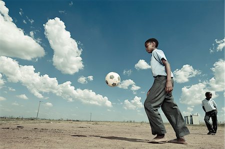 African school pupil plays with a soccer ball Stock Photo - Premium Royalty-Free, Code: 6110-08281166
